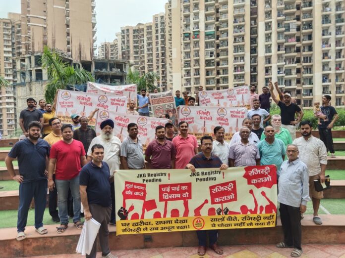Residents of JKG Palm Court in Greater Noida West stage protest and hang “Registry Ki Maang” banners from balconies, demanding start of flat registrations after 5 years of waiting. Residents of JKG Palm Court in Greater Noida West stage protest and hang “Registry Ki Maang” banners from balconies, demanding start of flat registrations after 5 years of waiting.