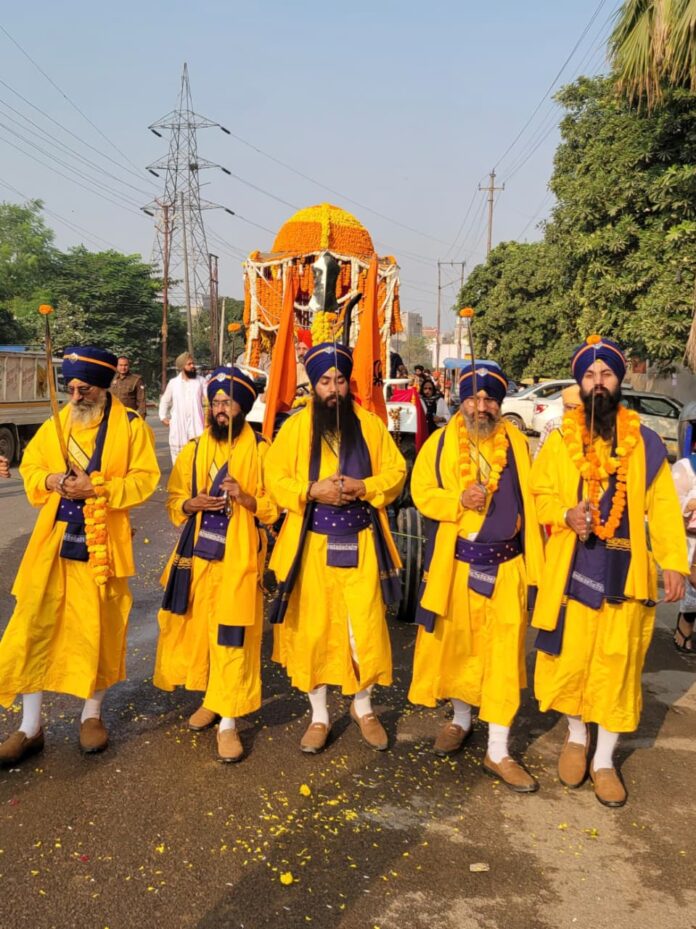 Panj Pyare leading the sacred procession with grace and devotion as Sangat follows in reverence Panj Pyare leading the sacred procession with grace and devotion as Sangat follows in reverence