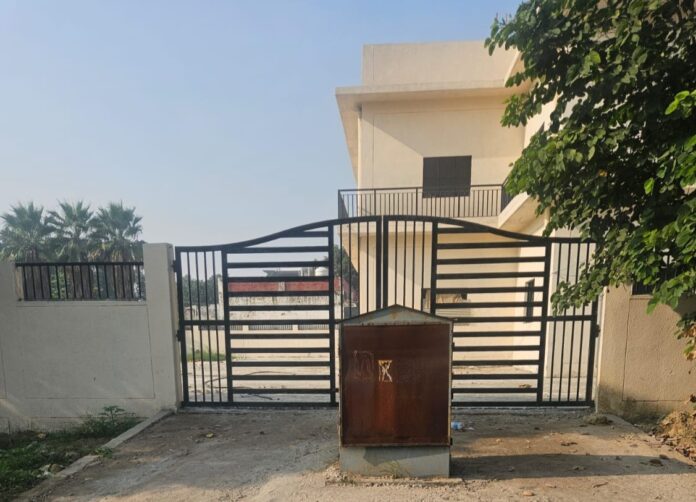 The electricity panel box installed right in front of the main gate of the newly constructed community centre in Sector Delta-3, creating a major entry obstruction for residents. The electricity panel box installed right in front of the main gate of the newly constructed community centre in Sector Delta-3, creating a major entry obstruction for residents.