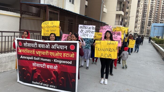 Residents of Amrapali Golf Homes stage a symbolic protest with banners and drums against the Adhoc AOA alleging misuse of maintenance funds and lack of transparency. Residents of Amrapali Golf Homes stage a symbolic protest with banners and drums against the Adhoc AOA alleging misuse of maintenance funds and lack of transparency.