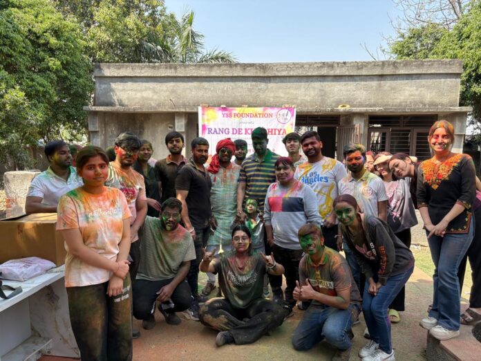 Street children celebrate Holi with eco-friendly colors, sweets and gifts during the “Rang De Khushiya” event organized by YSS Foundation at Yuva Street to School, Sector-126, Noida on March 1, 2026.