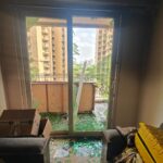 Smoke seen coming out of a flat at Migsun Ultimo, Greater Noida, as residents respond to another fire incident in the society.