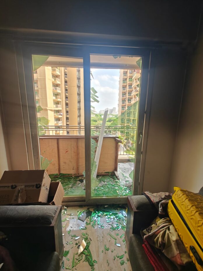 Smoke seen coming out of a flat at Migsun Ultimo, Greater Noida, as residents respond to another fire incident in the society.