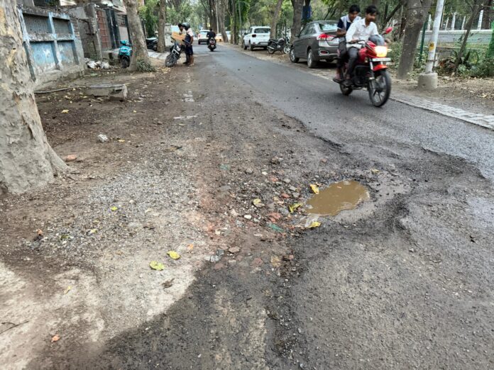 Crater-filled road in Beta-1 leaves commuters at risk, residents allege authority negligence