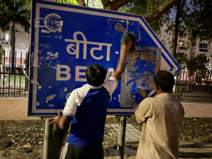RWA Beta-1 members clean direction signboards amid alleged inaction by Greater Noida Authority, demand stricter penalties for those defacing public spaces.