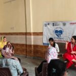 Radio Amity 107.8 FM and SMART Project teams interact with residents during a health awareness meeting in Barola, spreading information on vaccination and government healthcare schemes.