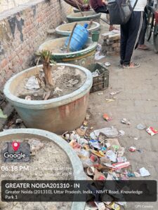 Dry plants and scattered garbage near Pari Chowk raise concerns over poor maintenance, residents demand immediate action from Greater Noida Authority.