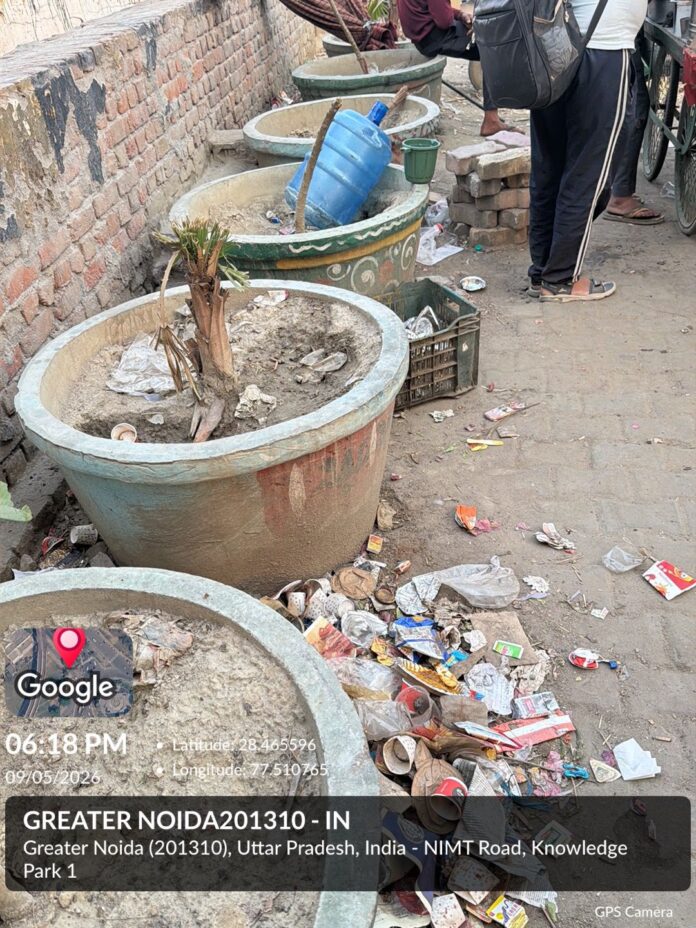 Dry plants and scattered garbage near Pari Chowk raise concerns over poor maintenance, residents demand immediate action from Greater Noida Authority.