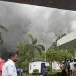Over 25 fire tenders rushed to Spark Minda’s Sector 59 facility after a massive fire engulfed parts of the factory, sending thick black smoke across Noida and prompting the evacuation of hundreds of workers.