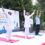Residents participate in a large-scale yoga session during the International Yoga Day celebration organized by RWA Sector 105 and Yatharth Hospital in Noida on June 21, 2026.
