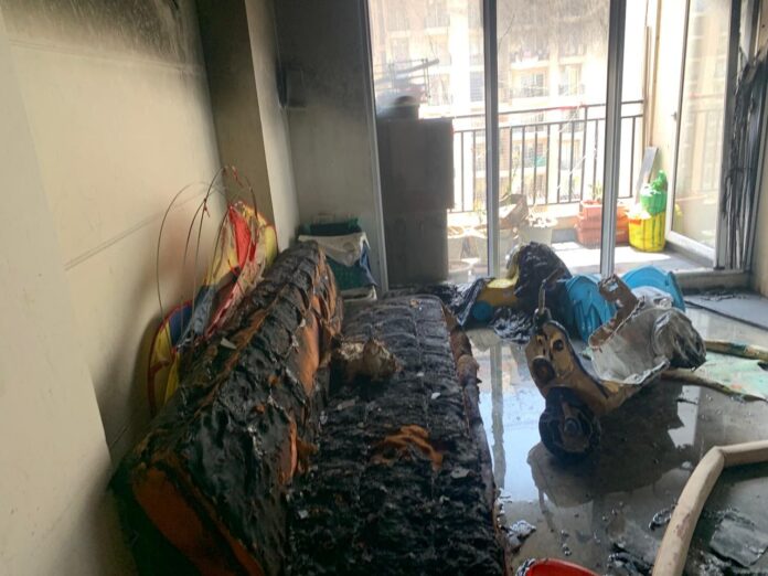 Smoke and flames rise from a flat in Exotica Dream Ville Society, Greater Noida West, after a fire allegedly triggered by a diya lit following a puja. Smoke and flames rise from a flat in Exotica Dream Ville Society, Greater Noida West, after a fire allegedly triggered by a diya lit following a puja.