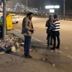 Noida Authority has formed night patrol teams to curb illegal garbage dumping on city roads between 10 pm and 4 am. For Apartment Times: Use an image that clearly shows garbage on a roadside/empty plot with a night-time enforcement feel. Avoid using an image of a garbage truck or a clean-up drive because it won't visually communicate the central news point.
