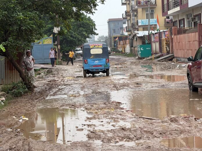 Damaged stretches of the road and waterlogging in Knowledge Park 3 have raised concerns over road quality, drainage and civic maintenance.