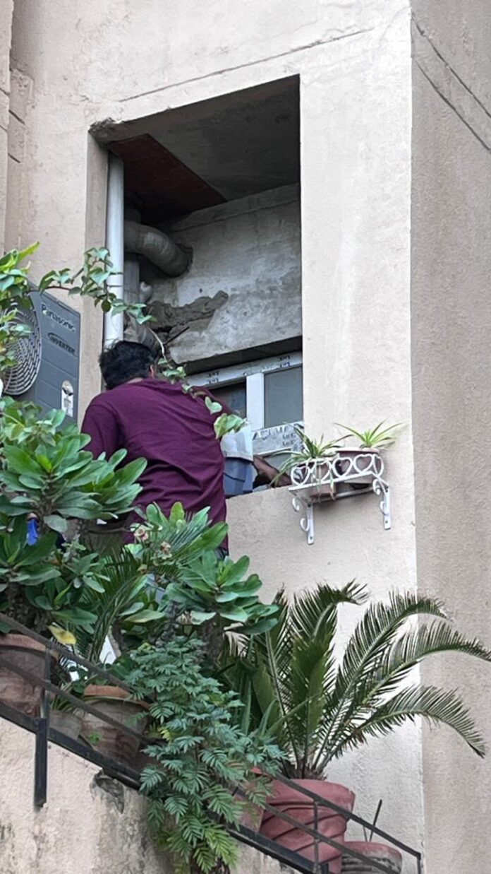 Rescue in action! A wildlife rescuer safely catches an owl at La Residentia Society, Greater Noida West.